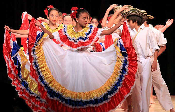 Twelve-year-old Betina Campos, center, performs with other Colombian students in a cumbia dance Wednesday at Cotter's St. Cecilia Theater in Winona. (Andrew Link/Winona Daily News)