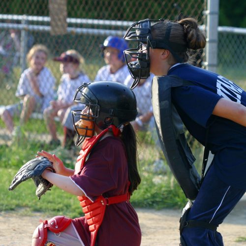 Both catcher and umpire are ready for the pitch. Girl's softball. Reference original photo IMG_8235.jpg taken June 8, 2005.